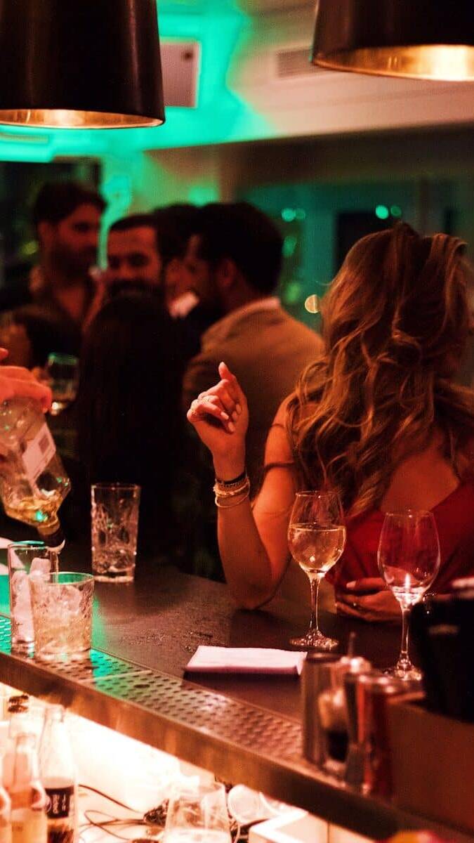 woman sits on the bar